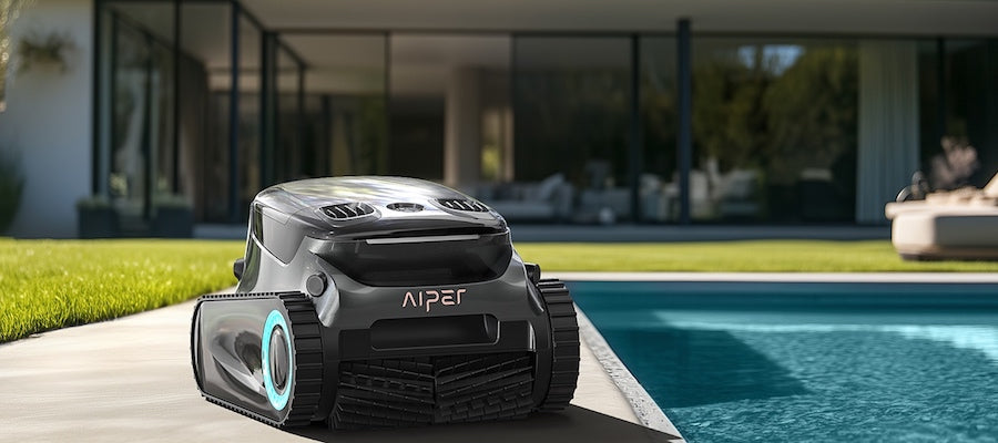 Robotic pool cleaner beside a modern swimming pool